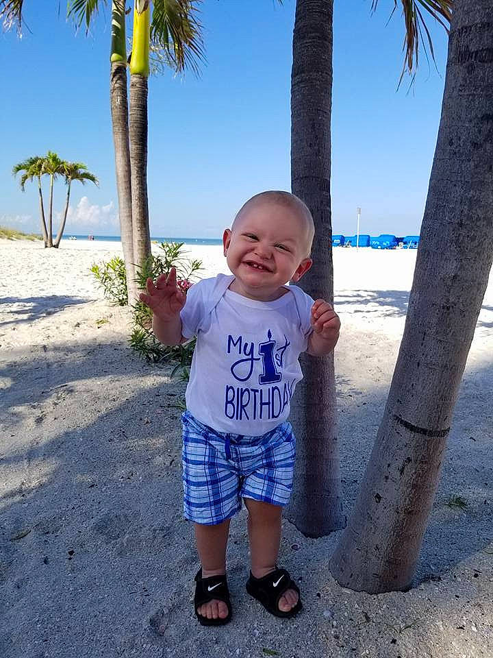 Riker is registered to the contest to win money with this photo: beach, blue, child, day, fun, joy, leisure, male, person, plant, recreation, sand, sky, smile, standing, summer, toddler, tourism, travel, tree