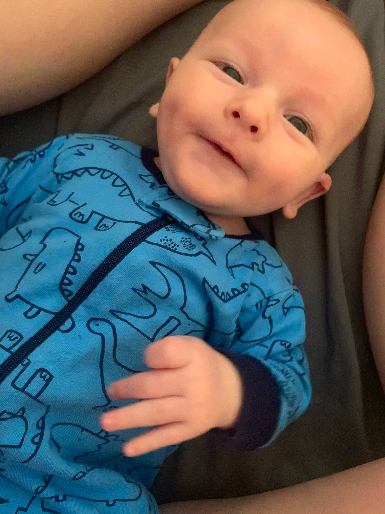 Jackson is registered to the contest to win money with this photo: arm, azure, baby, baby_toddler_clothing, cheek, comfort, eye, facial_expression, gesture, happy, head, mouth, muscle, neck, nose, organ, person, skin, sleeve, smile