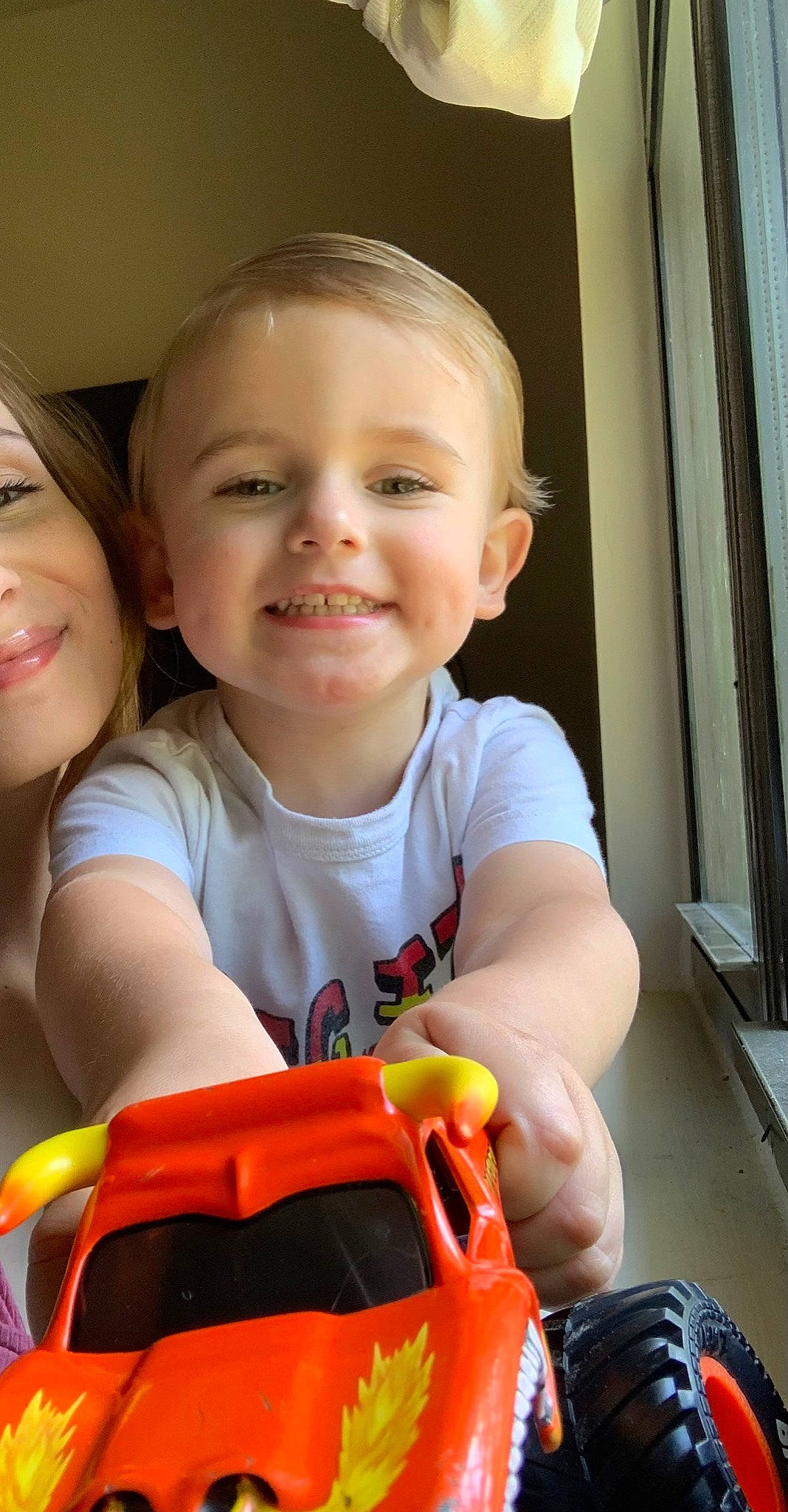 Caden is registered to the contest to win money with this photo: baby, baby_toddler_clothing, cheek, child, face, finger, fun, hand, happy, joy, leisure, mouth, muscle, nose, person, play, sitting, skin, smile, t_shirt