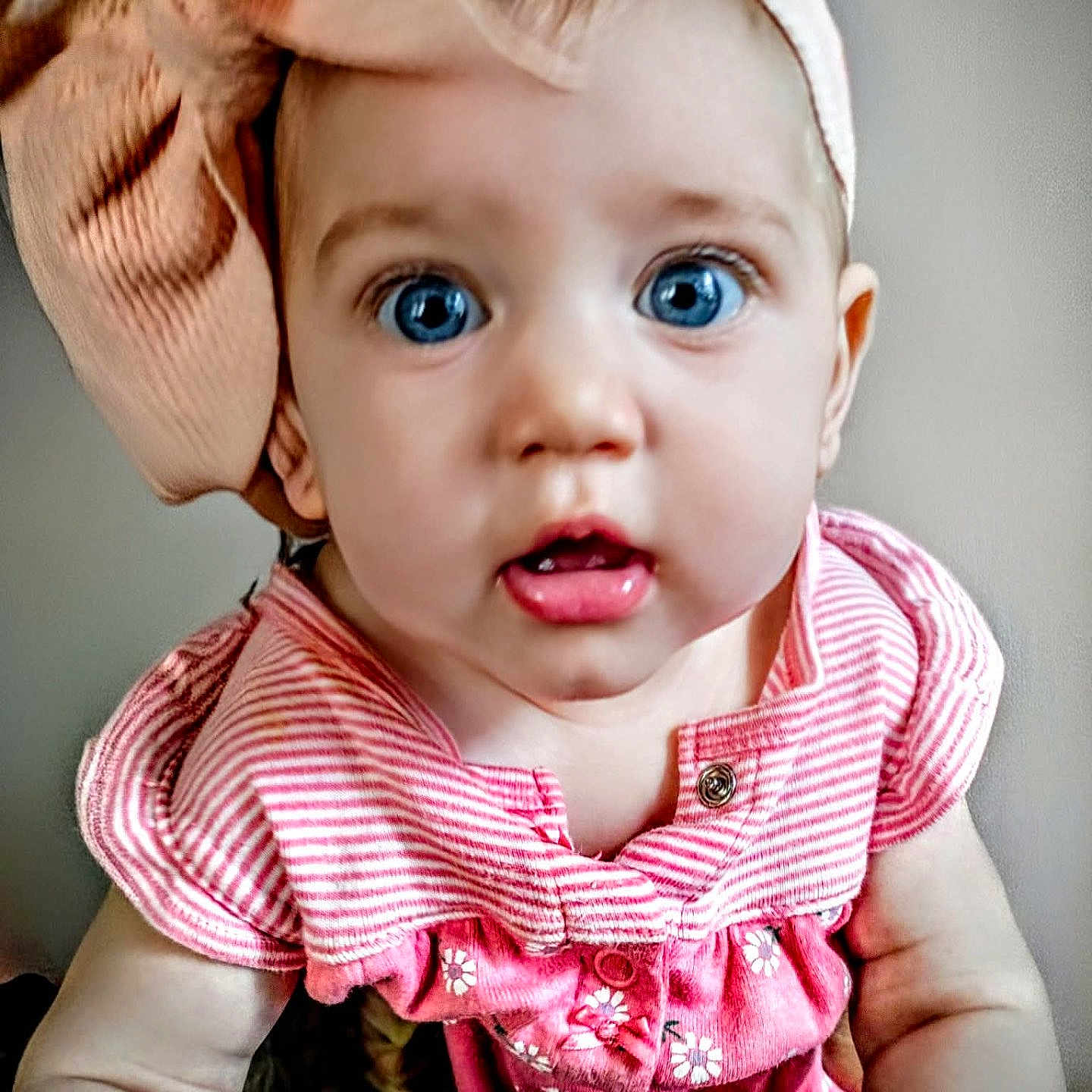 Addison joined the competition — help win amazing prizes! baby, child, blue_eyes, bow, pink_clothing, striped, floral_pattern, portrait, close_up, infant, cute, adorable, headband, young_child, expression, skin, sleeves, indoors, person, face