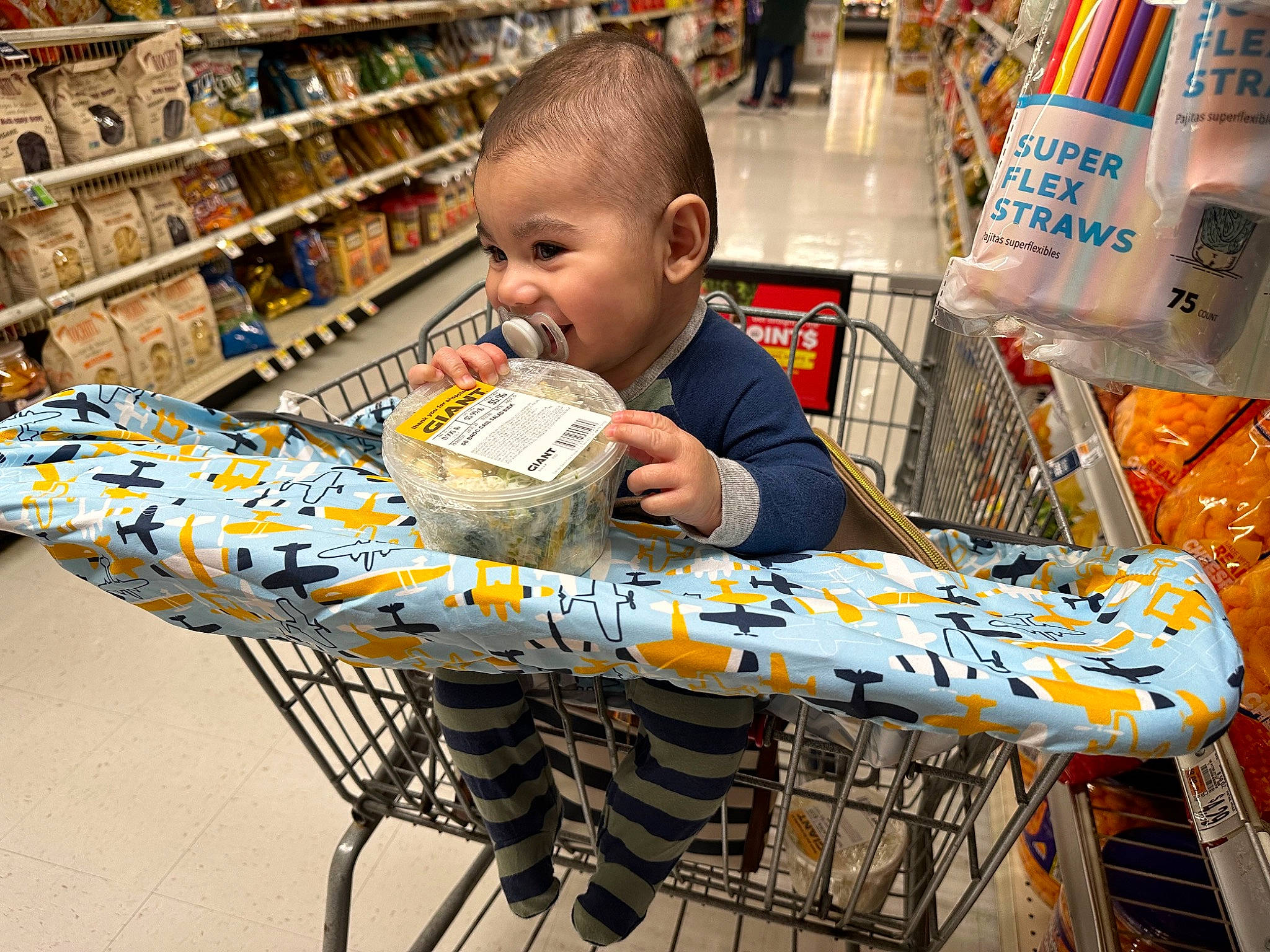 Maxwell is registered to the contest to win money with this photo: cart, convenience_store, customer, fun, grocery_store, market, marketplace, person, publication, recreation, retail, selling, service, shelf, shopping, shopping_cart, smile, supermarket, t_shirt, toddler