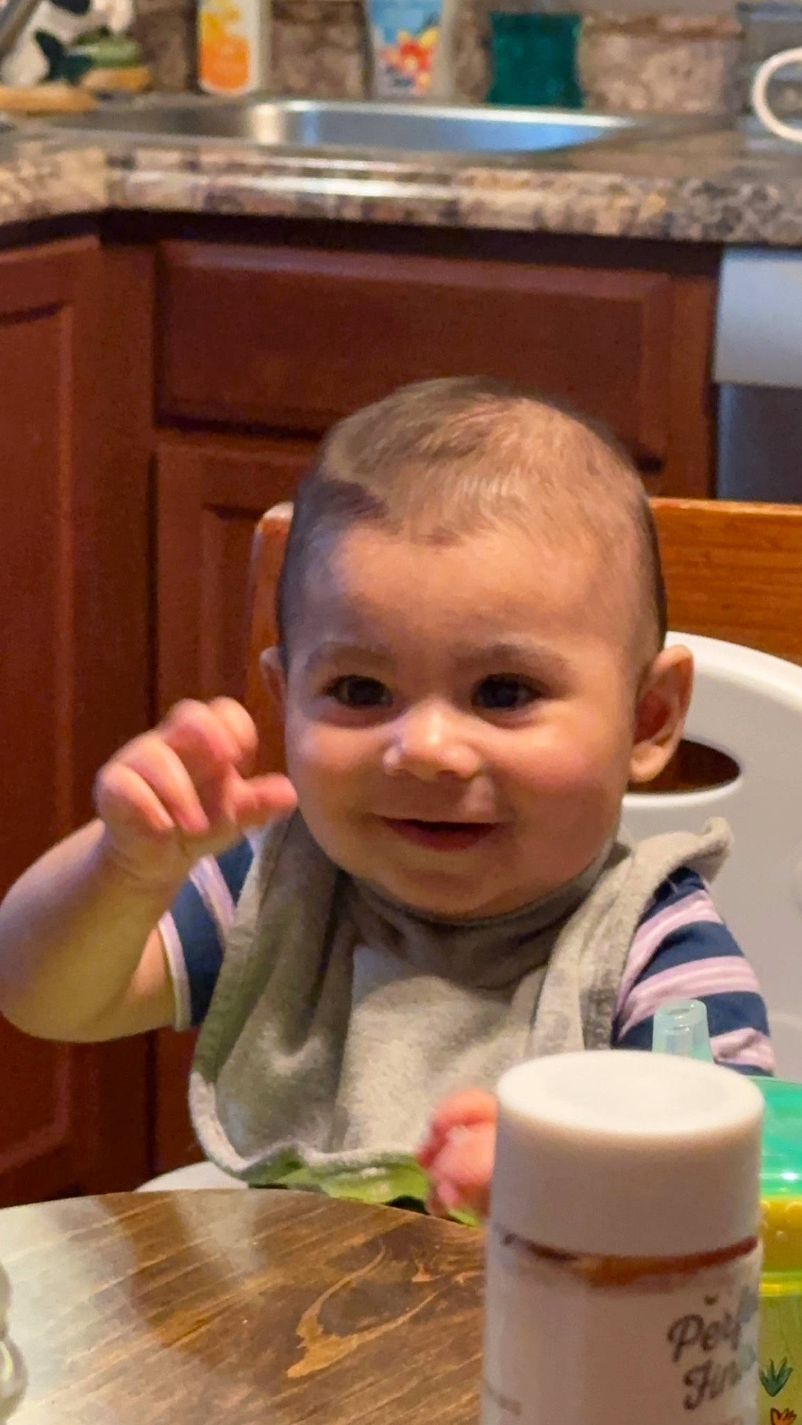 Maxwell is registered to the contest to win money with this photo: baby, chair, cheek, child, chin, eyelash, finger, fun, happy, head, joy, mouth, nose, person, sitting, skin, smile, table, tableware, thumb