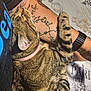 tabby_cat, cat, tattoo, arm, watch, pink_collar, striped_fur, pet, snuggling, cozy, relaxed, indoor, fabric, eiffel_tower, paris, human, closeup, animal, sleeping, resting