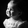 Léa participe au concours pour gagner de l'argent avec cette photo : child, toddler, smile, portrait, black_and_white, dress, embroidery, hair_clip, face, eyes, cheeks, soft_lighting, profile, cute, happy, infant, baby, studio, clothing, young_child