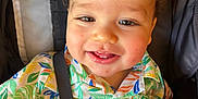 Miguel joined the competition — help win amazing prizes! toddler, child, smiling, happy, colorful_shirt, patterned_clothing, stroller, safety_strap, toy, cute, face, cheeks, eyes, hair, indoor, portrait, baby, seat, infant, playful