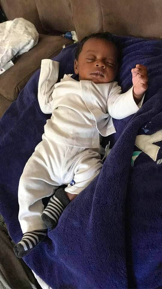 Mikeyon is registered to the contest to win money with this photo: baby, baby_products, baby_toddler_clothing, bedtime, child, comfort, formal_wear, fun, fur, gesture, happy, lap, linens, nap, person, room, sitting, skin, thumb, toddler