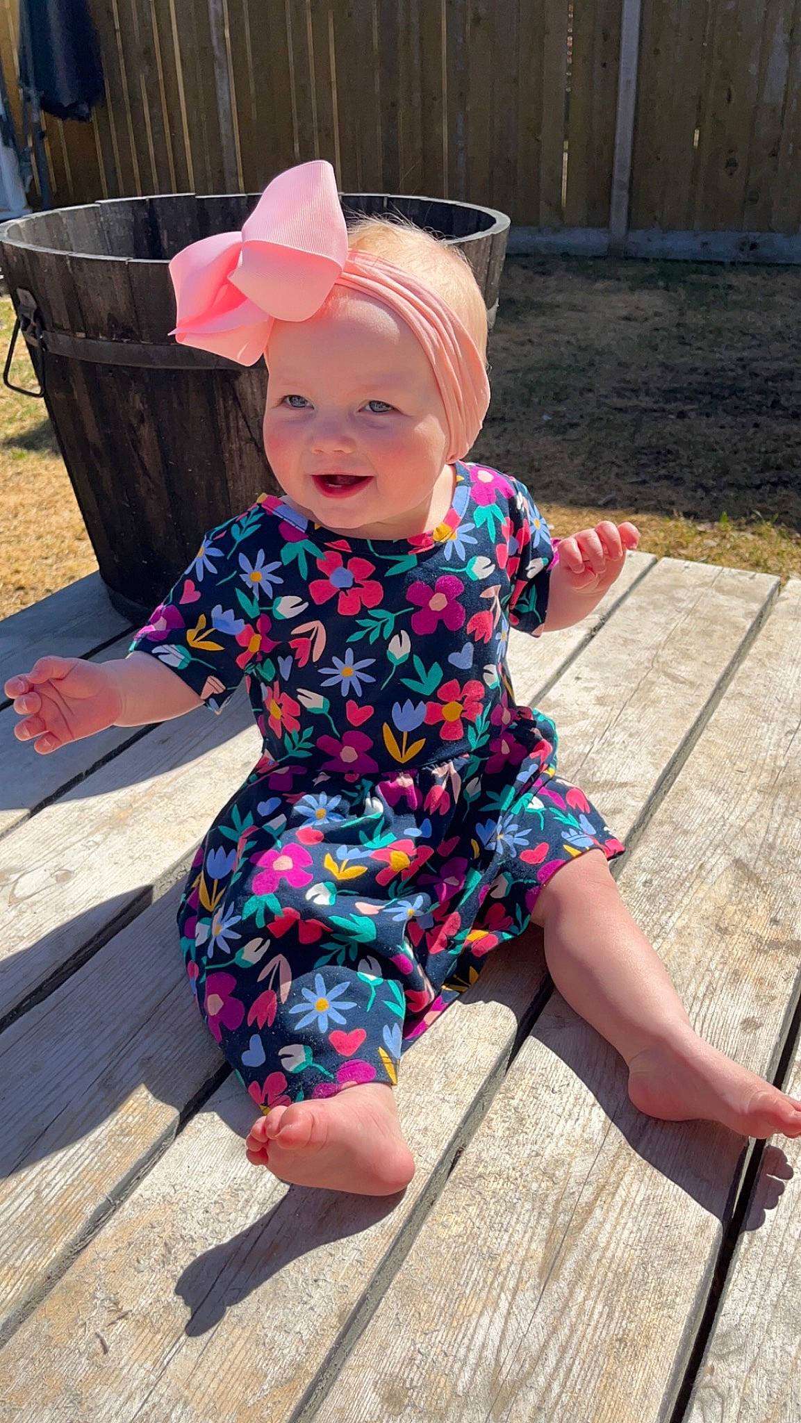 Scarlett is registered to the contest to win money with this photo: baby_toddler_clothing, child, fun, grass, happy, hat, headgear, headwear, human_leg, leisure, magenta, pattern, person, pink, sandal, sitting, sleeve, smile, summer, sun_hat