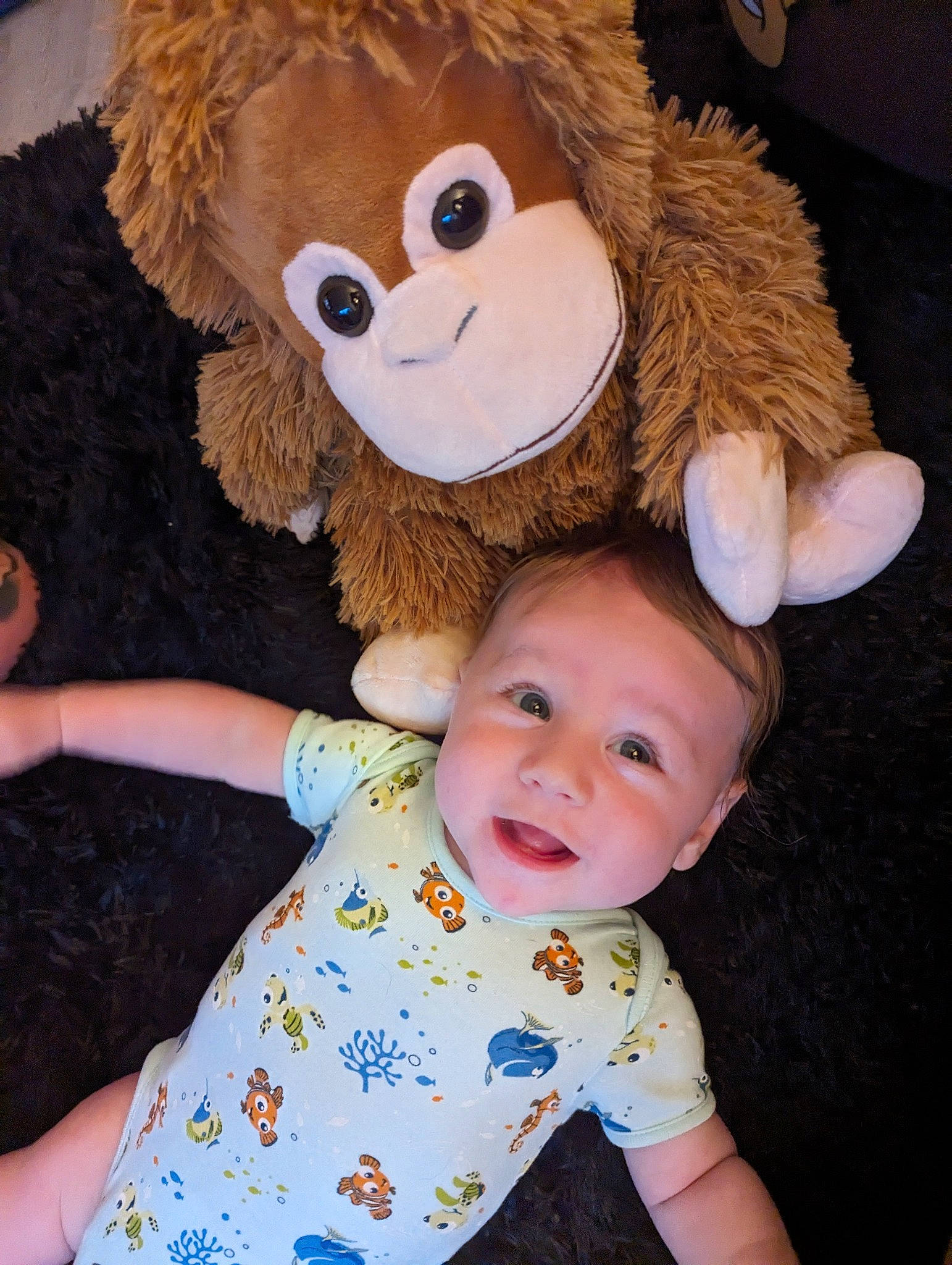 Noah is registered to the contest to win money with this photo: baby_toddler_clothing, cheek, child, fawn, finger, fun, gesture, happy, head, mammal, nose, person, skin, sleeve, smile, stuffed_toy, textile, toddler, toy, vertebrate