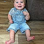 Levi joined the competition — help win amazing prizes! baby, child, smiling, denim_overalls, striped_shirt, blue_eyes, sitting, barefoot, wooden_floor, indoor, happy, cute, person, young_child, infant, couch, flooring, portrait, casual_clothing, home