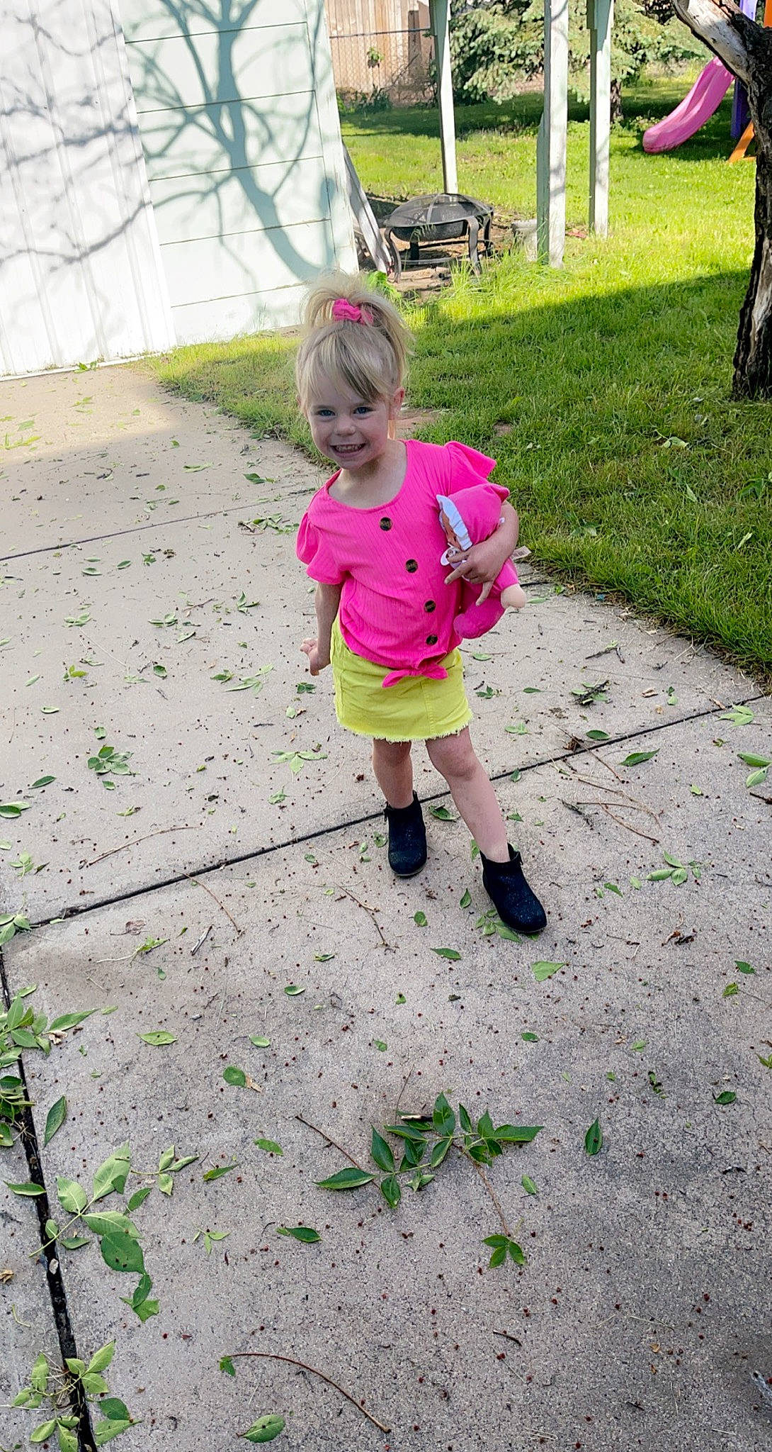 Kayzlee is registered to the contest to win money with this photo: baby_toddler_clothing, boot, child, fun, garden, grass, green, groundcover, joy, leisure, magenta, people_in_nature, person, plant, recreation, road_surface, sandal, shorts, soil, terrestrial_plant