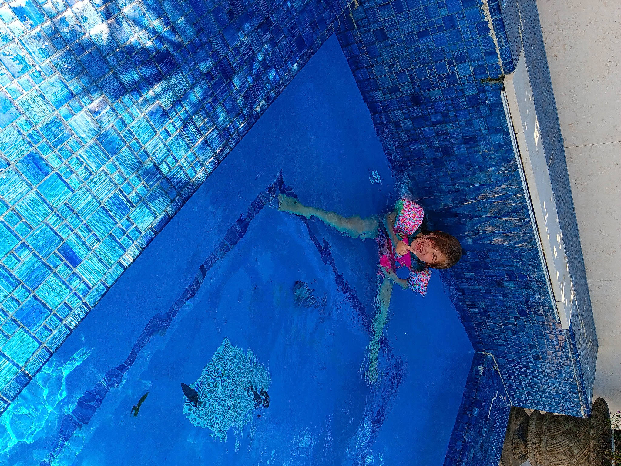 Mackenzie joined the competition — help win amazing prizes! aqua, azure, blue, composite_material, concrete, electric_blue, fun, leisure, liquid, paint, pattern, person, plaster, recreation, reflection, swimming_pool, wall, water, wood, world