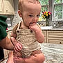Jacob joined the competition — help win amazing prizes! baby, infant, child, kitchen, countertop, hand, fingers, couching, person, flowers, vase, window, natural_light, cabinet, appliance, marble_surface, support, cute, curious, indoors