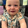 Jacob joined the competition — help win amazing prizes! baby, child, smiling, face, eyes, shirt, patterned_clothing, high_chair, indoor, home, window, ceiling_fan, table, furniture, hands, person, portrait, happy, closeup, infant