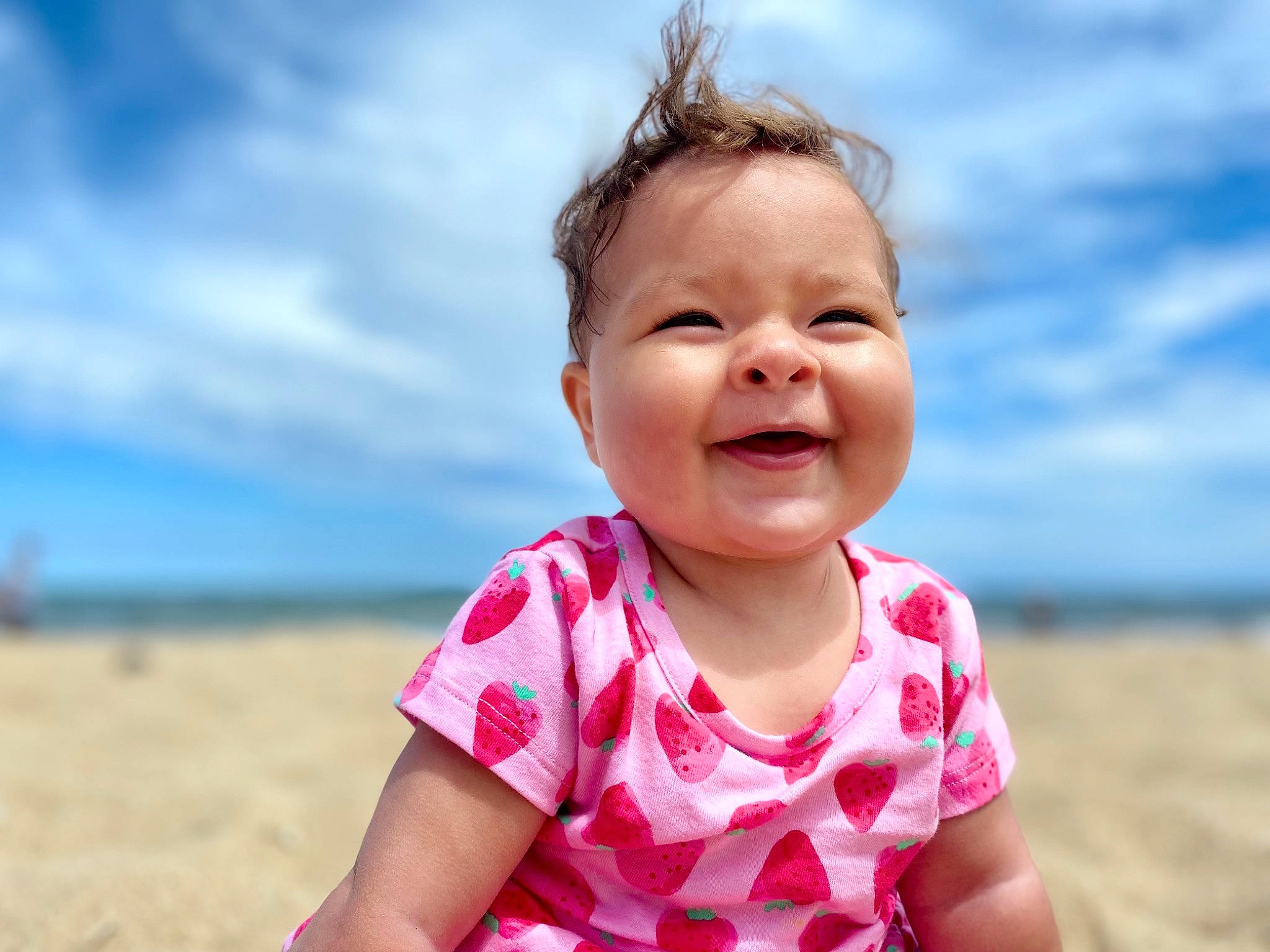 Eliza joined the competition — help win amazing prizes! baby_toddler_clothing, beach, chin, cloud, eye, face, flash_photography, happy, head, leisure, lip, mouth, people_in_nature, people_on_beach, person, skin, sky, sleeve, smile, toddler