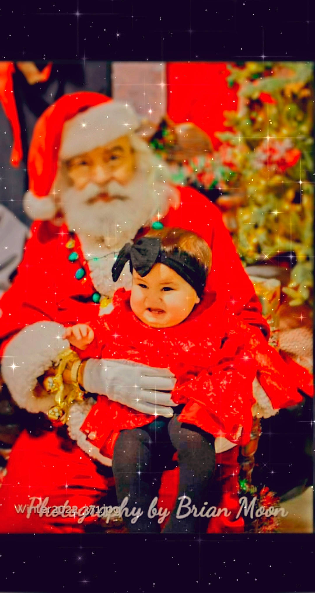 Leilani is registered to the contest to win money with this photo: baby, beard, child, christmas, christmas_decoration, christmas_eve, christmas_ornament, christmas_tree, event, fictional_character, fun, happy, headwear, holiday, ornament, person, santa_claus, smile, toddler, tradition