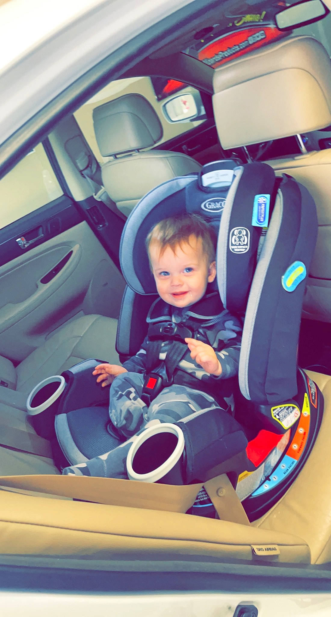 Malakai joined the competition — help win amazing prizes! auto_part, automotive_design, automotive_exterior, automotive_wheel_system, car, car_seat, car_seat_cover, electric_blue, land_vehicle, light, mode_of_transport, motor_vehicle, person, personal_luxury_car, plant, product, smile, steering_wheel, toddler, vehicle
