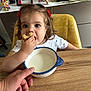 Catalina a rejoint le concours — aidez-le/la à gagner de superbes lots ! bowl, chair, child, colorful, curly_hair, cute, decor, eating, face, furniture, hair_clips, hand, home, indoor, milk, person, photograph, snack, table, toddler