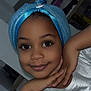 Këziah a rejoint le concours — aidez-le/la à gagner de superbes lots ! child, face, smile, eyes, hand, pose, towel, turban, clothing, silver_shirt, indoor, portrait, cute, young, person, happy, skin, headwear, expression, childhood