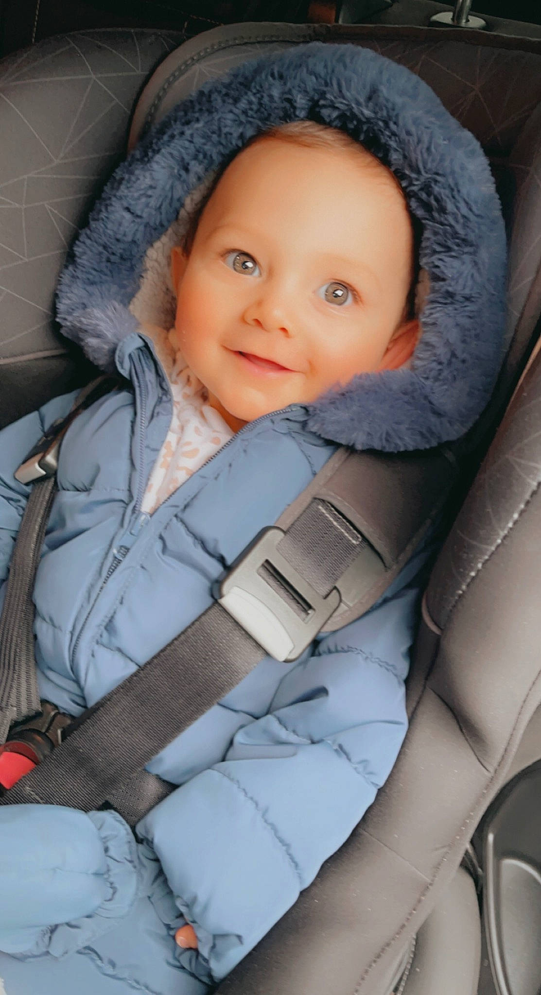 Ronnie is registered to the contest to win money with this photo: auto_part, baby, baby_carriage, baby_in_car_seat, baby_products, baby_safety, car_seat, car_seat_cover, cheek, child, comfort, electric_blue, eyebrow, face, facial_expression, head_restraint, joy, person, seat_belt, skin