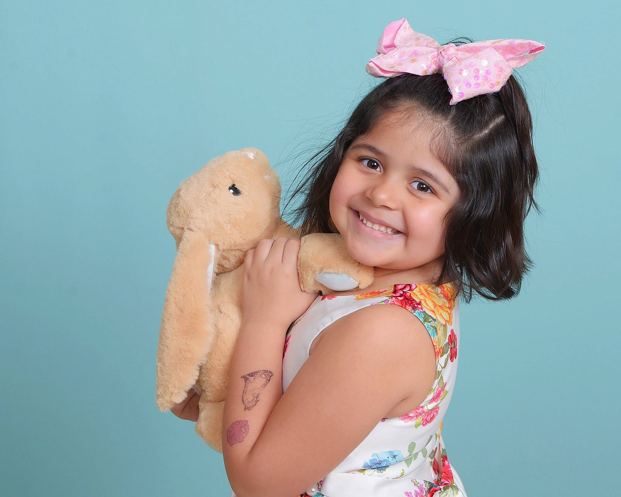 Athena is registered to the contest to win money with this photo: arm, azure, baby_toddler_clothing, beauty, child, costume_hat, dress, elbow, fun, gesture, hairstyle, happy, head, joy, person, pink, skin, smile, thumb, toddler