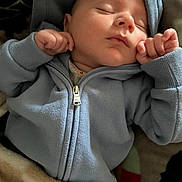 Ashtyn joined the competition — help win amazing prizes! baby, sleeping, hoodie, blue_clothing, blanket, infant, cozy, peaceful, fist, soft_texture, face, portrait, closeup, child, young, resting, warm, indoor, cute, newborn