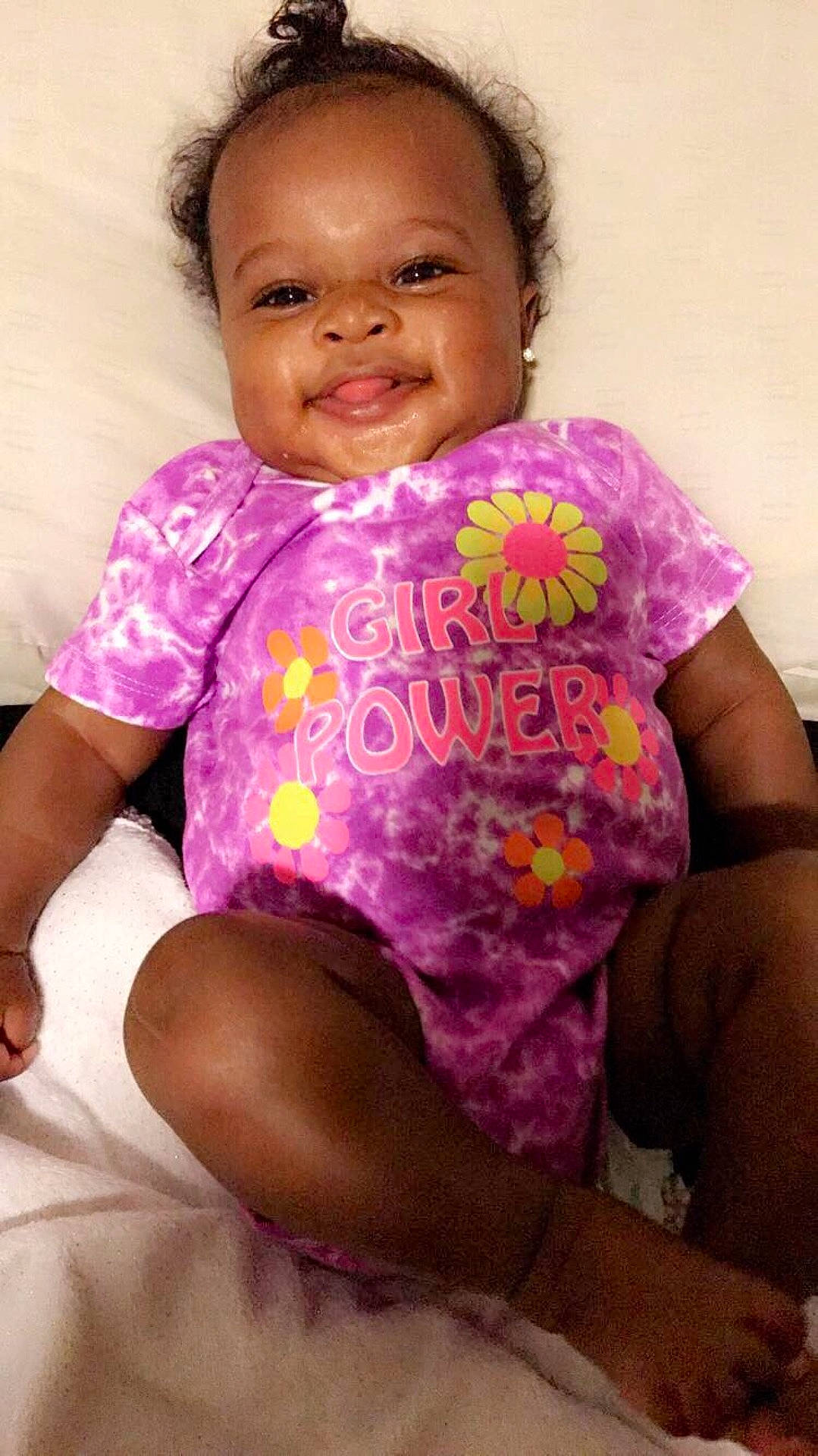 Kylie is registered to the contest to win money with this photo: abdomen, cheek, child, finger, girl, infant, magenta, mouth, person, pink, product, purple, skin, smile, toddler, trunk