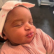 Comfort is registered to the contest to win money with this photo: adorable, baby, bow, child, close_up, clothing, cute, face, head, human, indoors, infant, newborn, peaceful, pink_headband, portrait, ribbed_clothing, skin, sleeping, soft_light