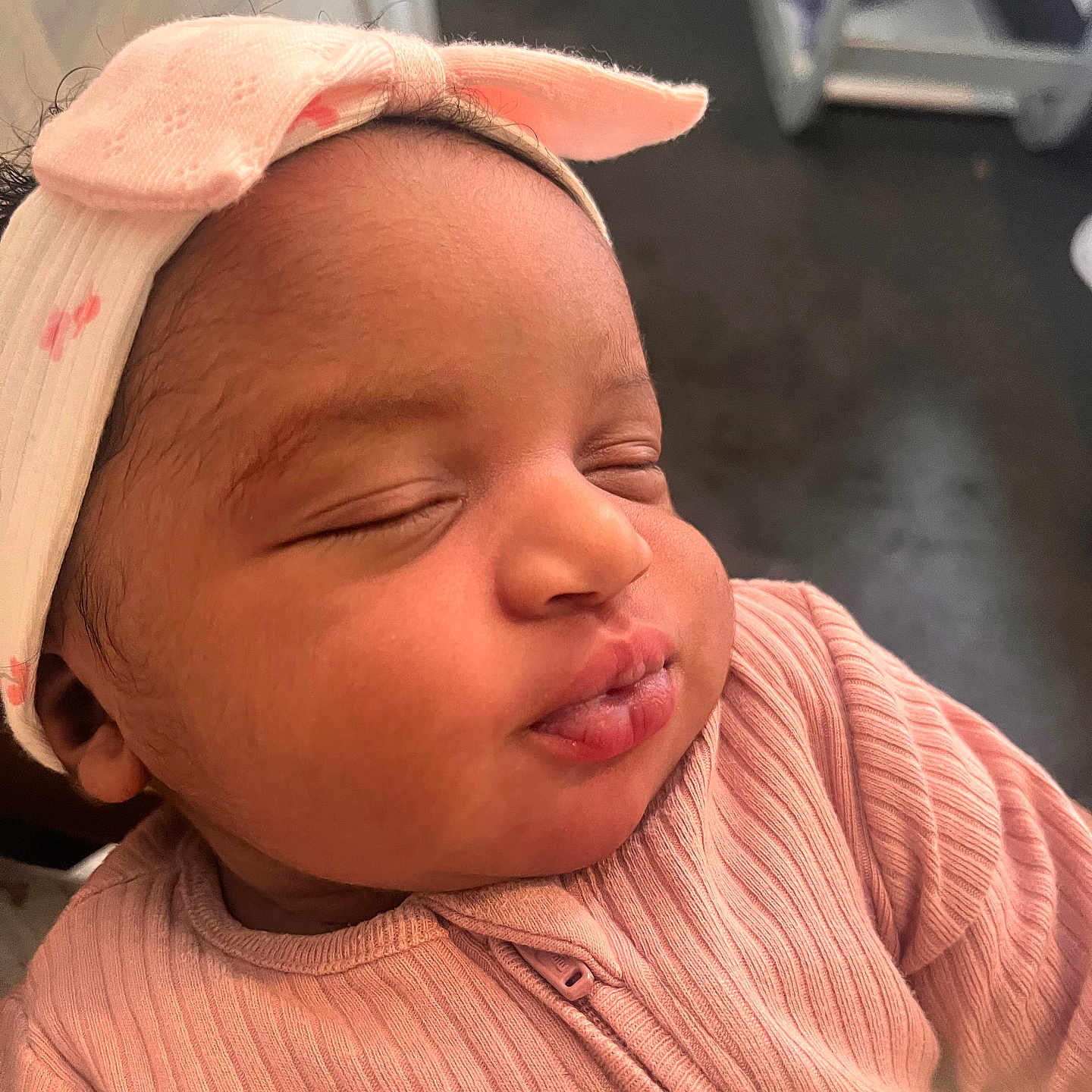 Comfort is registered to the contest to win money with this photo: adorable, baby, bow, child, close_up, clothing, cute, face, head, human, indoors, infant, newborn, peaceful, pink_headband, portrait, ribbed_clothing, skin, sleeping, soft_light