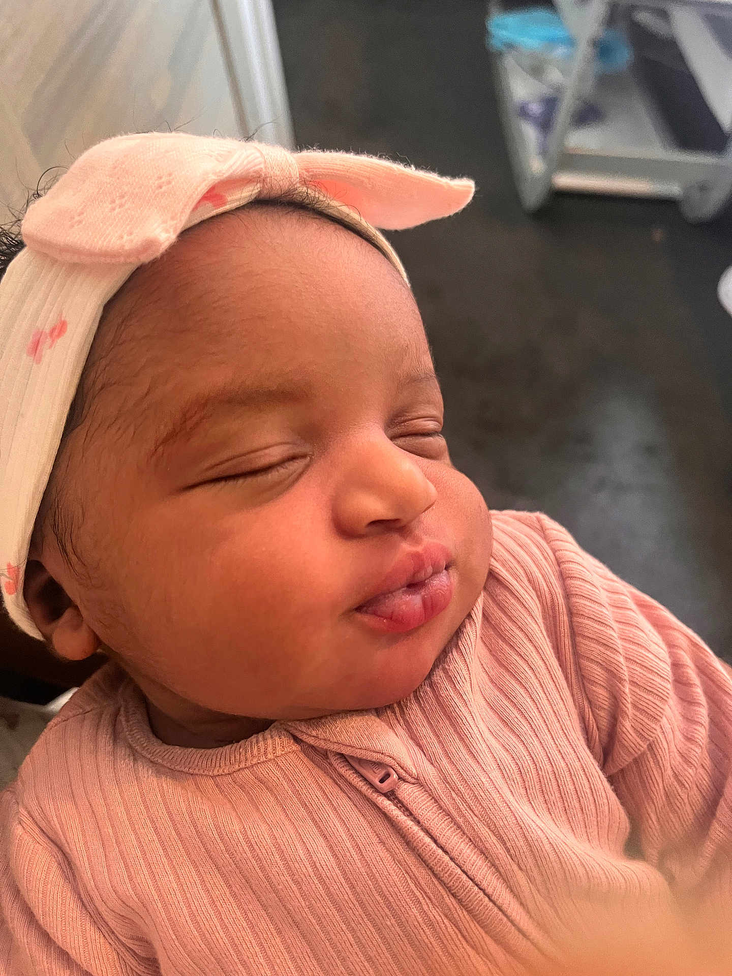 Comfort is registered to the contest to win money with this photo: adorable, baby, bow, child, close_up, clothing, cute, face, head, human, indoors, infant, newborn, peaceful, pink_headband, portrait, ribbed_clothing, skin, sleeping, soft_light