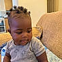 Chantel is registered to the contest to win money with this photo: baby, child, indoor, couch, blanket, hair_puffs, curly_hair, gray_shirt, infant, portrait, sitting, cute, skin, face, young_child, cozy, soft_lighting, home, casual_clothing, relaxed