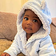 Chantel joined the competition — help win amazing prizes! baby, child, hoodie, blue_clothing, couch, indoor, portrait, cute, face, hand, knitted, fuzzy, warm, young_child, infant, looking_at_camera, cozy, soft_texture, home, seated