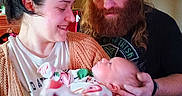 Sunniva joined the competition — help win amazing prizes! woman, man, baby, indoor, family, holding, smiling, beard, hat, casual_clothing, love, care, cozy, portrait, newborn, affection, warmth, head_support, sweater, peaceful