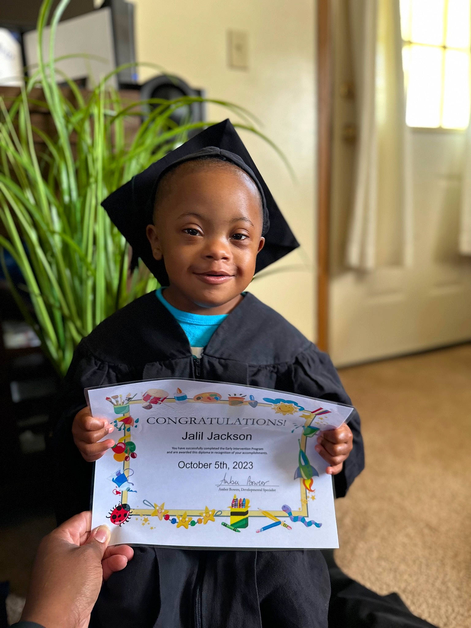 Jalil is registered to the contest to win money with this photo: adaptation, child, event, fun, handwriting, happy, houseplant, joy, people, person, plant, play, recreation, room, sharing, sleeve, smile, snapshot, t_shirt, toddler