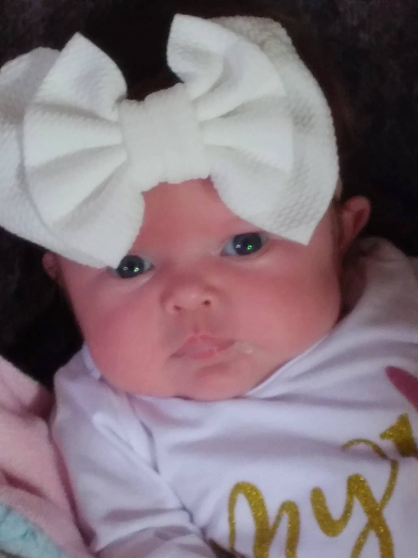 Paige is registered to the contest to win money with this photo: baby, baby_products, baby_toddler_clothing, bonnet, cap, cheek, child, comfort, eyebrow, eyelash, fashion_accessory, hat, headwear, human_body, linens, lip, person, skin, sleeve, toddler
