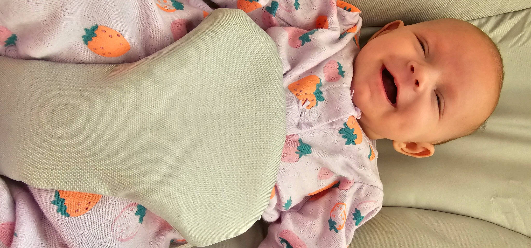 Brynlee is registered to the contest to win money with this photo: baby, baby_products, baby_toddler_clothing, cheek, child, comfort, finger, hand, human_body, joy, linens, lip, mouth, nose, person, pink, product, skin, sleeve, smile