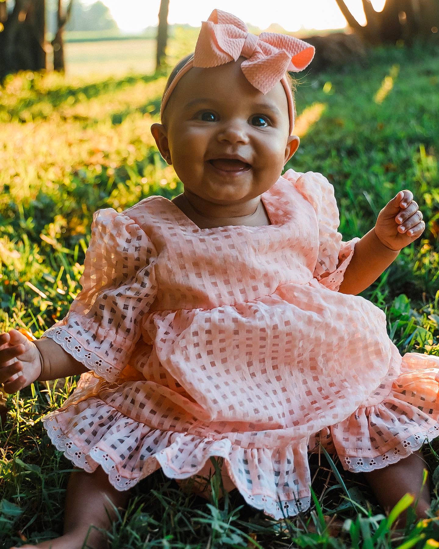 Evie joined the competition — help win amazing prizes! baby, baby_toddler_clothing, botany, child, dress, facial_expression, fawn, finger, grass, grass_family, happy, lip, people_in_nature, person, photograph, pink, plant, skin, smile, summer