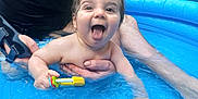 Eiji participe au concours pour gagner de l'argent avec cette photo : adult, baby, child, fun, garden, greenery, hand, happy, outdoor, person, play, pool, smile, splash, summer, sunlight, tongue, toy, water, wrist_brace