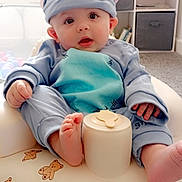Layton joined the competition — help win amazing prizes! baby, infant, child, blue_outfit, animal_hat, inflatable_seat, teddy_bear_print, indoor, carpet, cute, curious, wide_eyes, hand, foot, soft_lighting, toy_storage, bookshelf, home, portrait, smiling