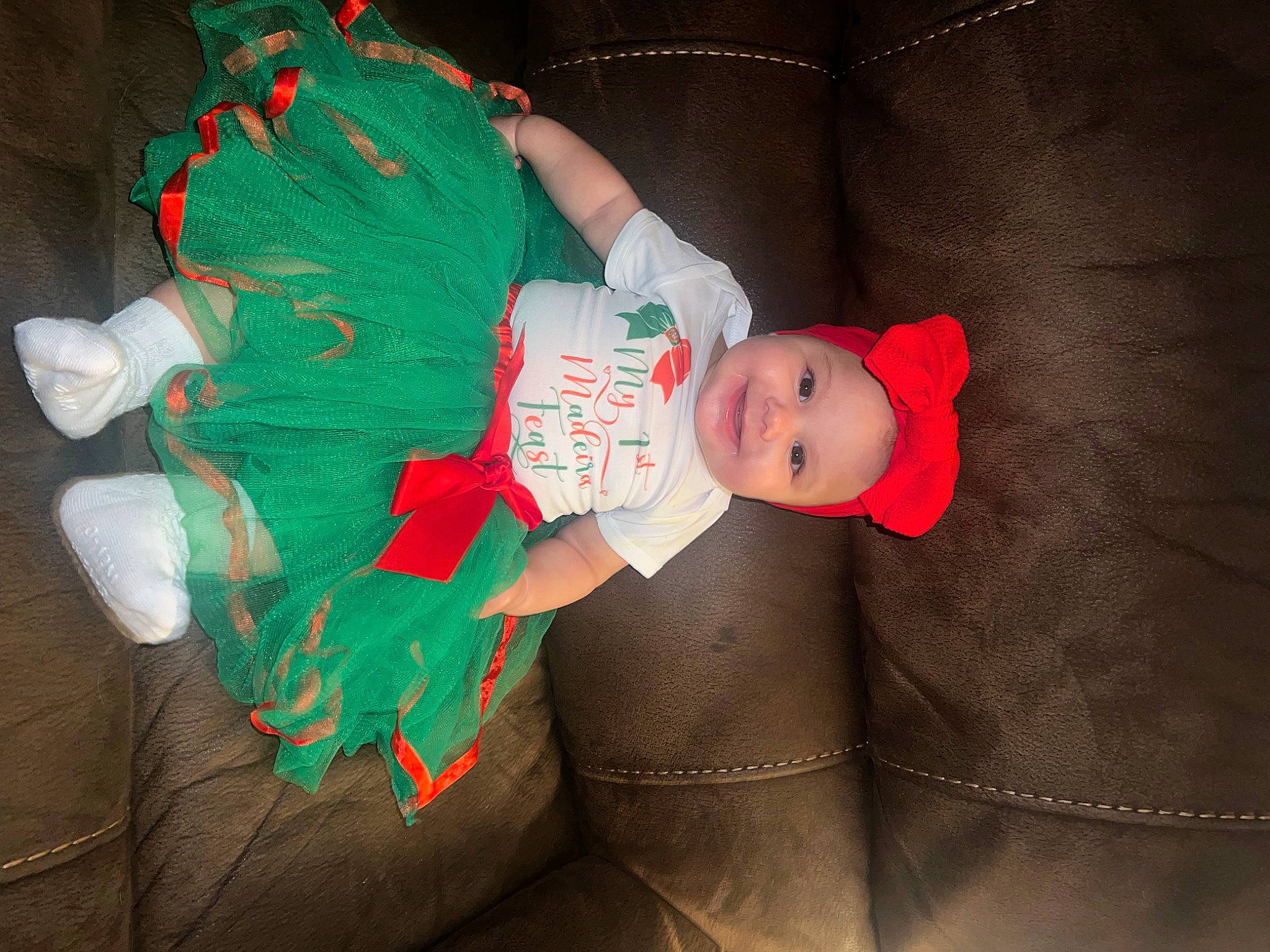 Mazie is registered to the contest to win money with this photo: baby, baby_toddler_clothing, carmine, child, christmas, christmas_eve, christmas_ornament, comfort, costume_hat, event, fictional_character, fun, hat, head, headwear, holiday, joy, lap, person, room