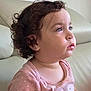 Tahel a rejoint le concours — aidez-le/la à gagner de superbes lots ! toddler, child, curly_hair, pink_shirt, polka_dot, couch, indoor, portrait, side_view, face, earring, soft_light, young_child, casual_clothing, person, seated, expression, skin, head, looking_away
