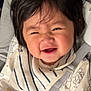 baby, child, smiling, happy, car_seat, seatbelt, bib, clothing, infant, face, hair, cute, patterned_clothing, indoors, closeup, strapped, toddler, person, cheerful, expression