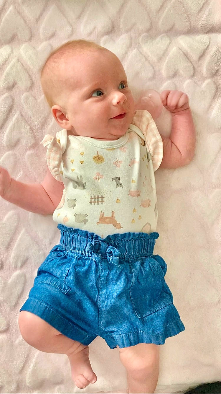 Vanessa joined the competition — help win amazing prizes! arm, baby, baby_toddler_clothing, cheek, child, eye, face, facial_expression, finger, happy, head, iris, pattern, person, pink, skin, sleeve, textile, thigh, toddler