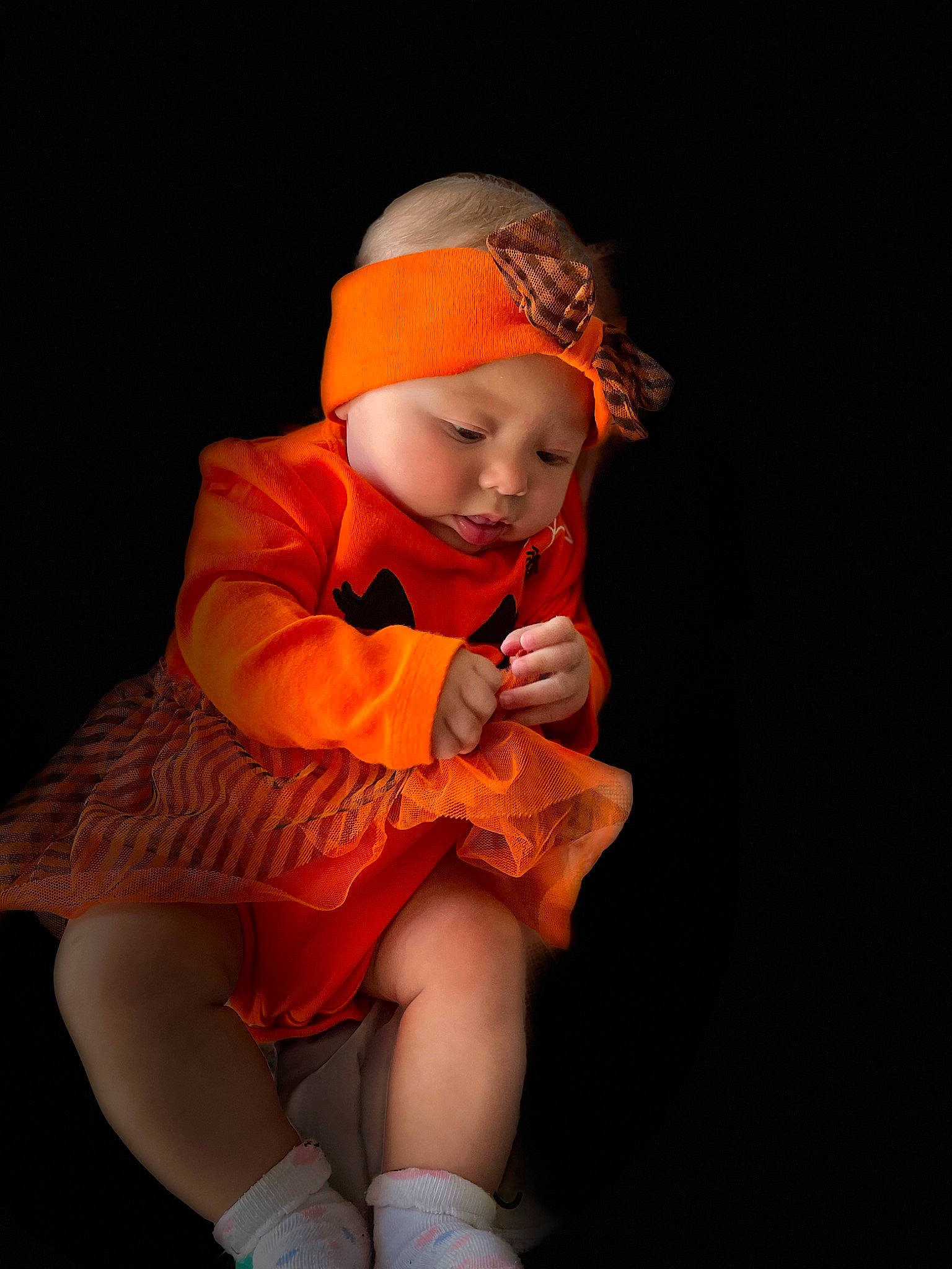 Mackenzie is registered to the contest to win money with this photo: baby, baby_toddler_clothing, beanie, child, costume, event, flash_photography, flesh, fun, headwear, human_leg, knee, lap, peach, person, sitting, sleeve, sock, thigh, thumb
