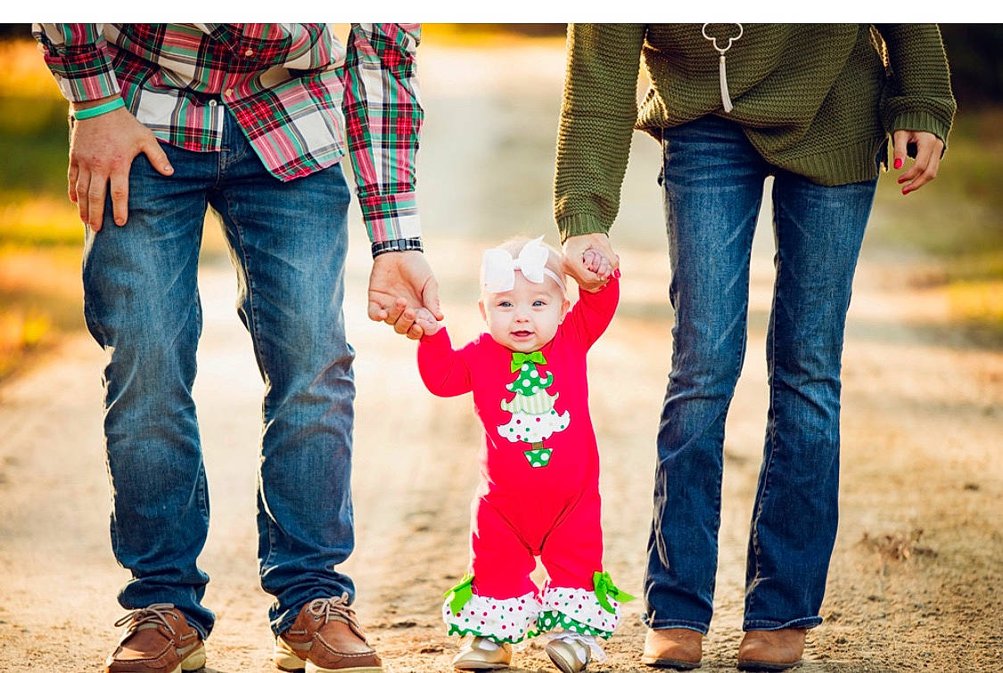 Brylee is registered to the contest to win money with this photo: child, denim, footwear, fun, gesture, green, holding_hands, interaction, jeans, leg, male, people, people_in_nature, person, photograph, photography, plaid, red, standing, toddler
