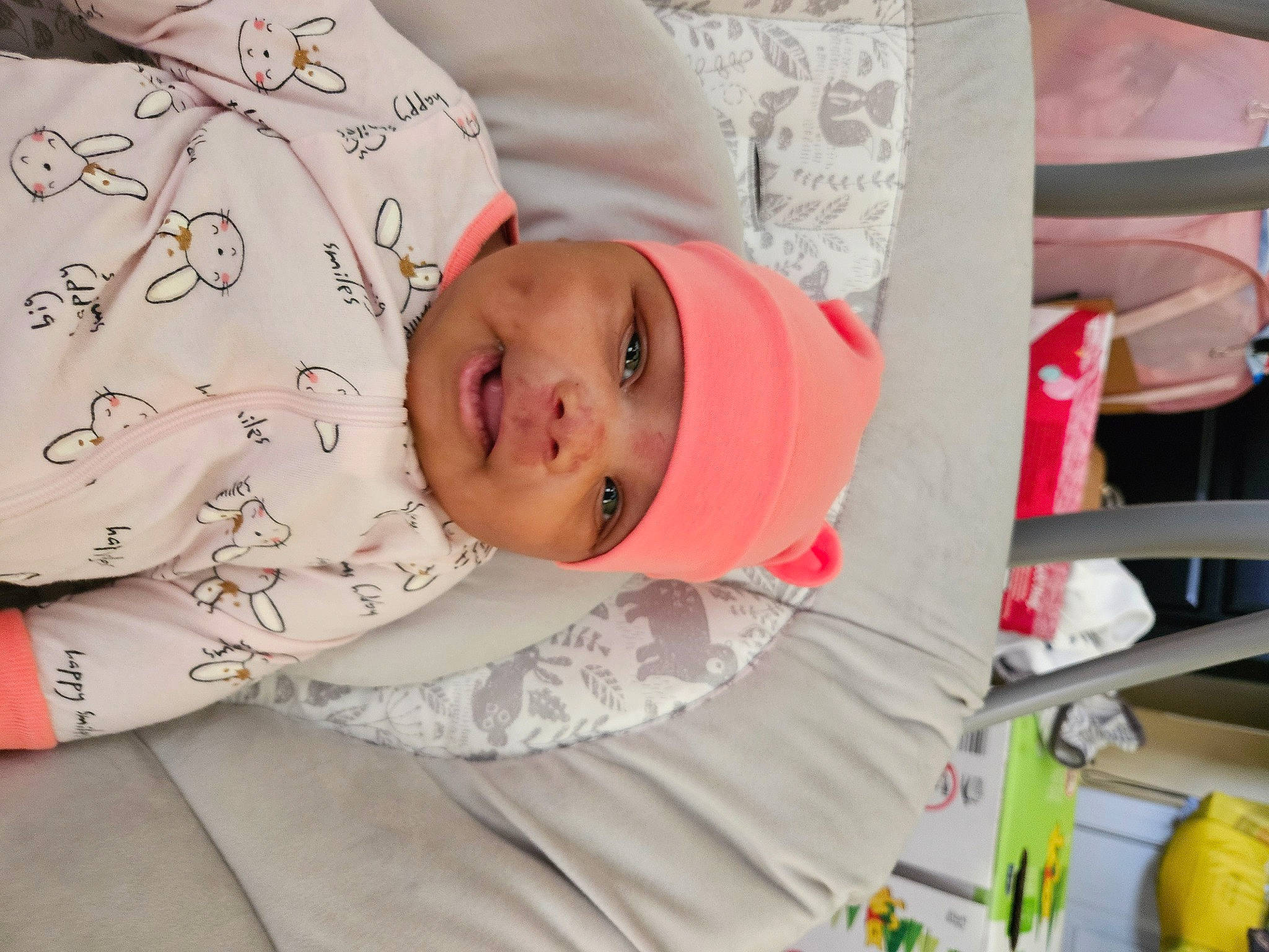 Khloe joined the competition — help win amazing prizes! baby, baby_products, baby_toddler_clothing, child, comfort, eye, face, happy, hat, headwear, linens, pattern, person, pink, room, sleeve, smile, textile, toddler, toy