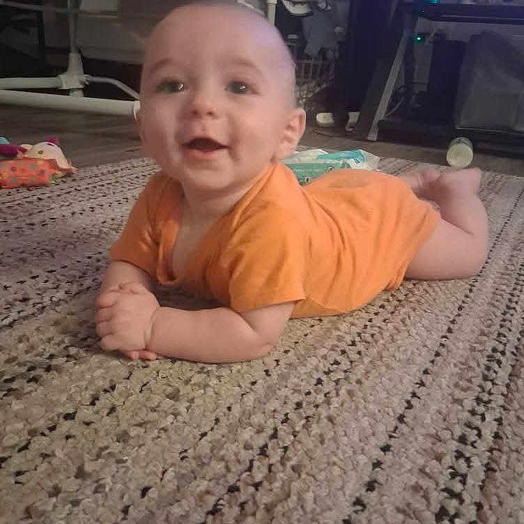 Forrest joined the competition — help win amazing prizes! baby, carpet, child, crawling, cute, floor, flooring, furniture, hands, happy, head, home, indoor, infant, orange_onesie, person, rug, smiling, toy, young