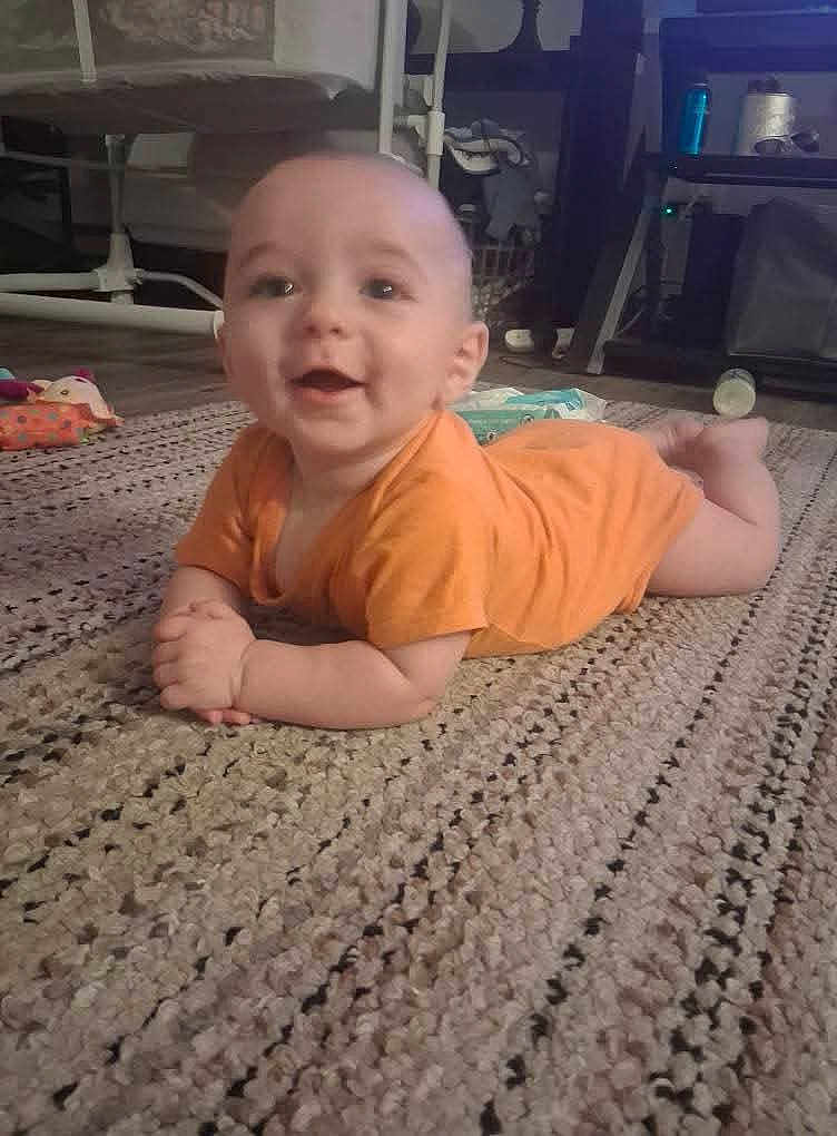 Forrest joined the competition — help win amazing prizes! baby, infant, orange_onesie, rug, floor, indoor, furniture, toy, happy, smiling, child, crawling, person, carpet, home, cute, young, hands, head, flooring