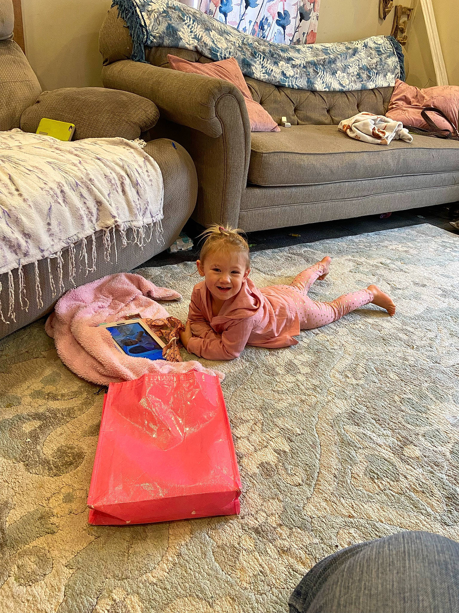 Harper is registered to the contest to win money with this photo: bedding, carpet, comfort, couch, floor, flooring, hardwood, interior_design, joy, leisure, linens, living_room, person, pillow, pink, room, sofa_bed, studio_couch, textile, throw_pillow