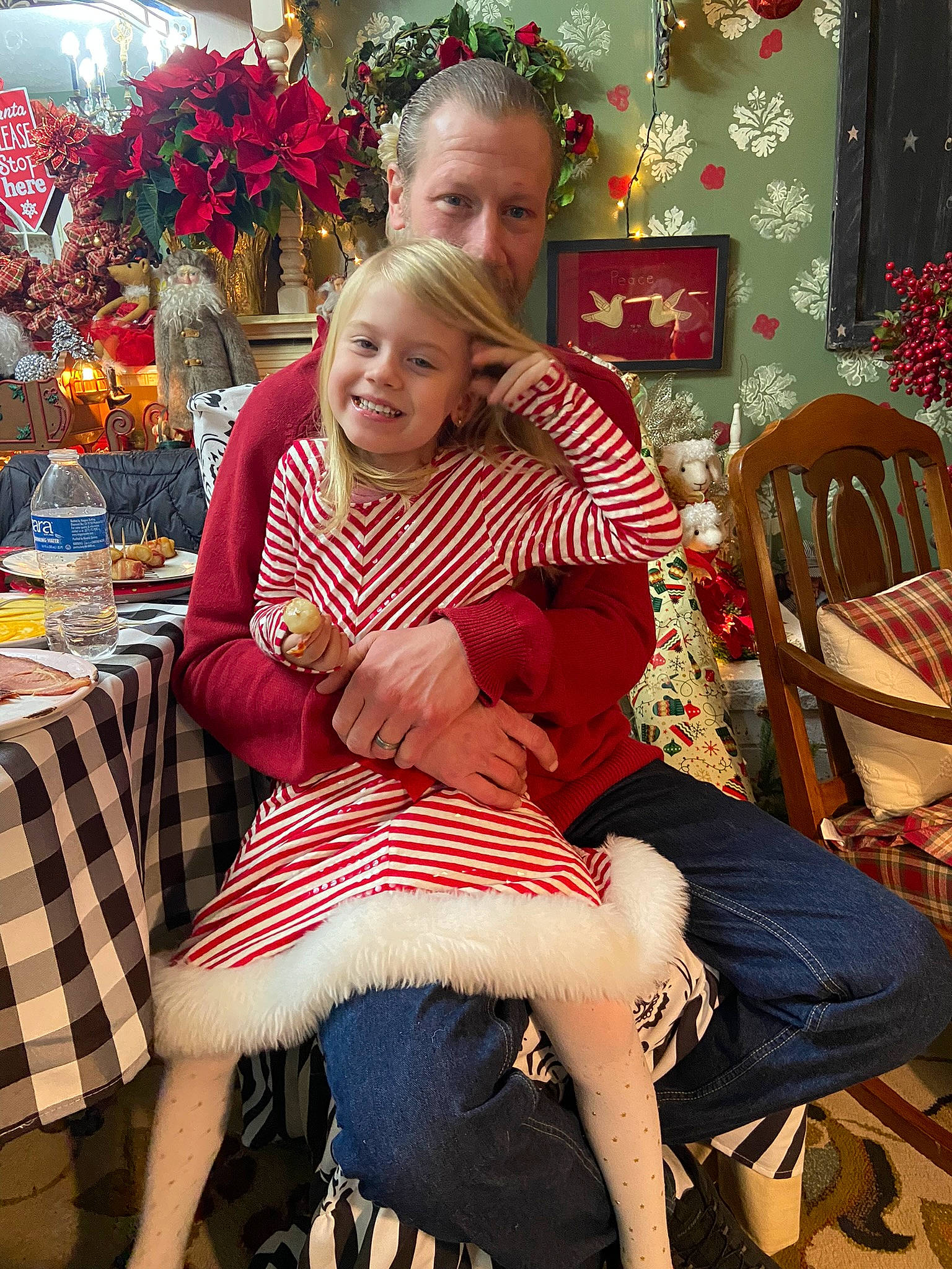 Addilyn is registered to the contest to win money with this photo: beauty, chair, child, christmas_decoration, christmas_ornament, comfort, event, fun, furniture, happy, holiday, human_leg, joy, knee, lap, leg, person, photograph, sitting, smile