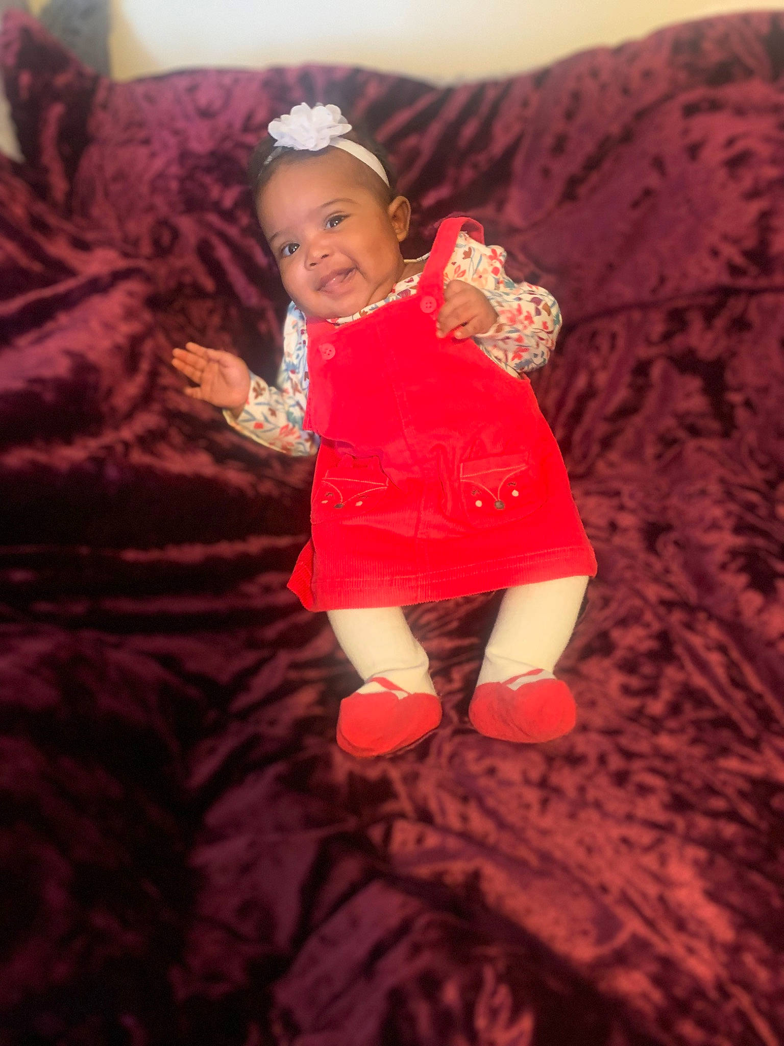 Seyven is registered to the contest to win money with this photo: baby, baby_toddler_clothing, child, comfort, couch, finger, floor, flooring, fun, gesture, happy, human_leg, joy, orange, person, pink, skin, sleeve, smile, textile